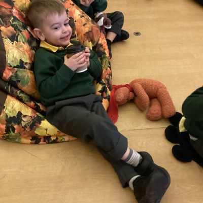Enjoying a story together with a cookie and a hot chocolate at the start of Park Road World Book Week