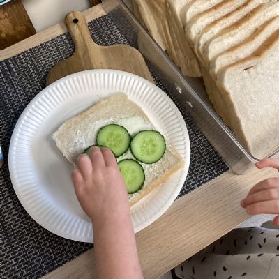 Preparing cheese and cucumber sandwiches for tasting