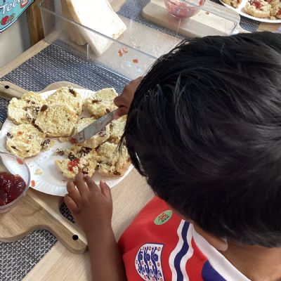 Preparing jam and scones for tasting