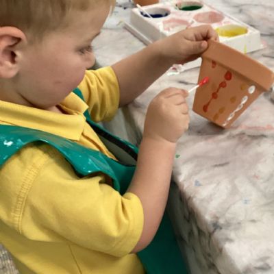 Painting our own plant pot during Park Road in Bloom